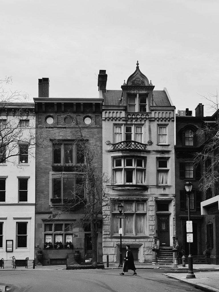 Black and white photo of quaint old rowhomes 